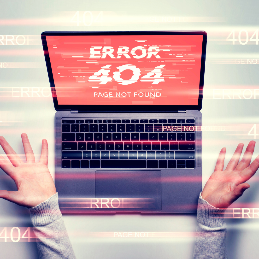 A laptop displaying a "404 Error: Page Not Found" message, with a person’s hands raised in frustration.